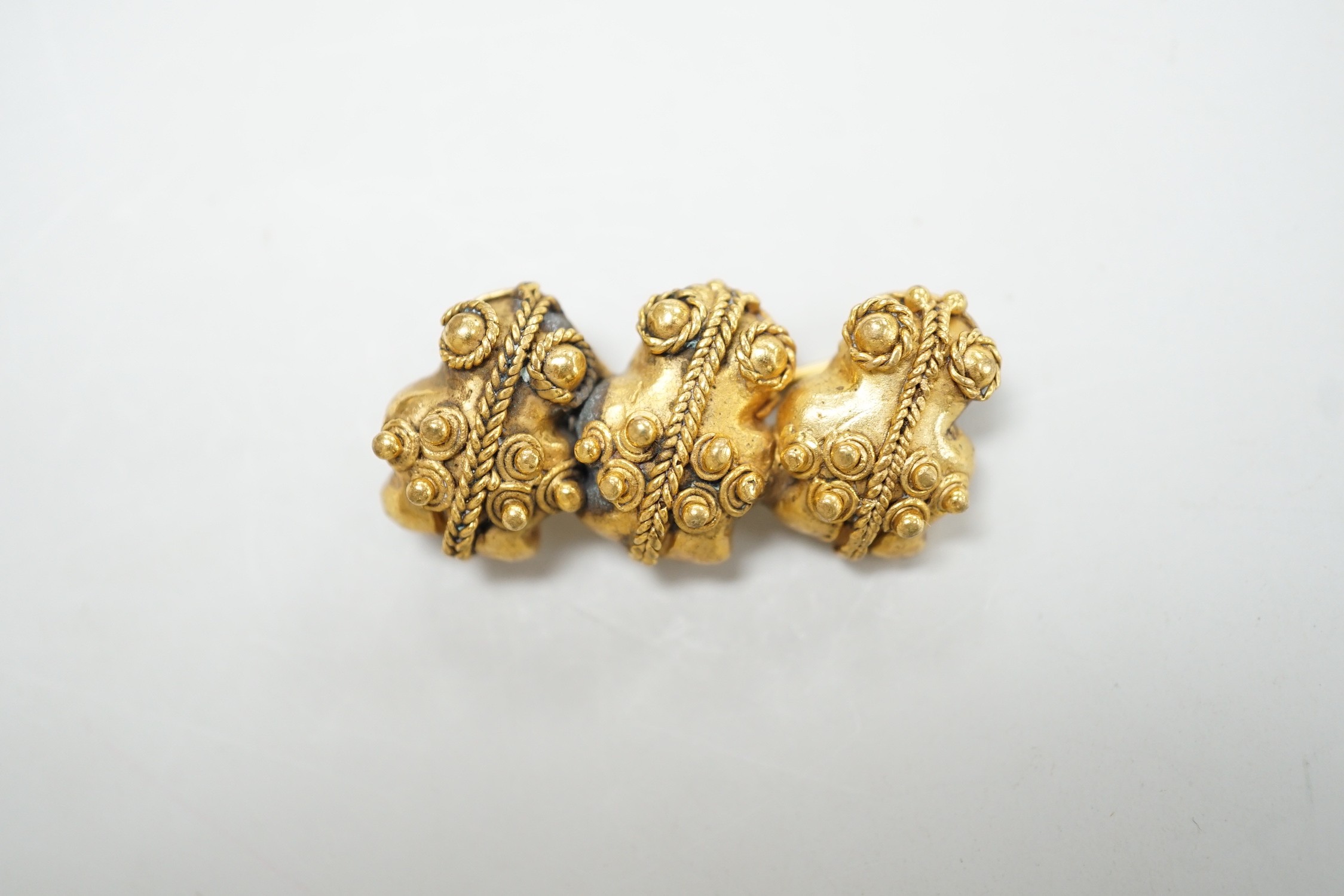 A heavy yellow metal three sectional bar brooch with applied ropework detail, 37mm, 14.5 grams.
